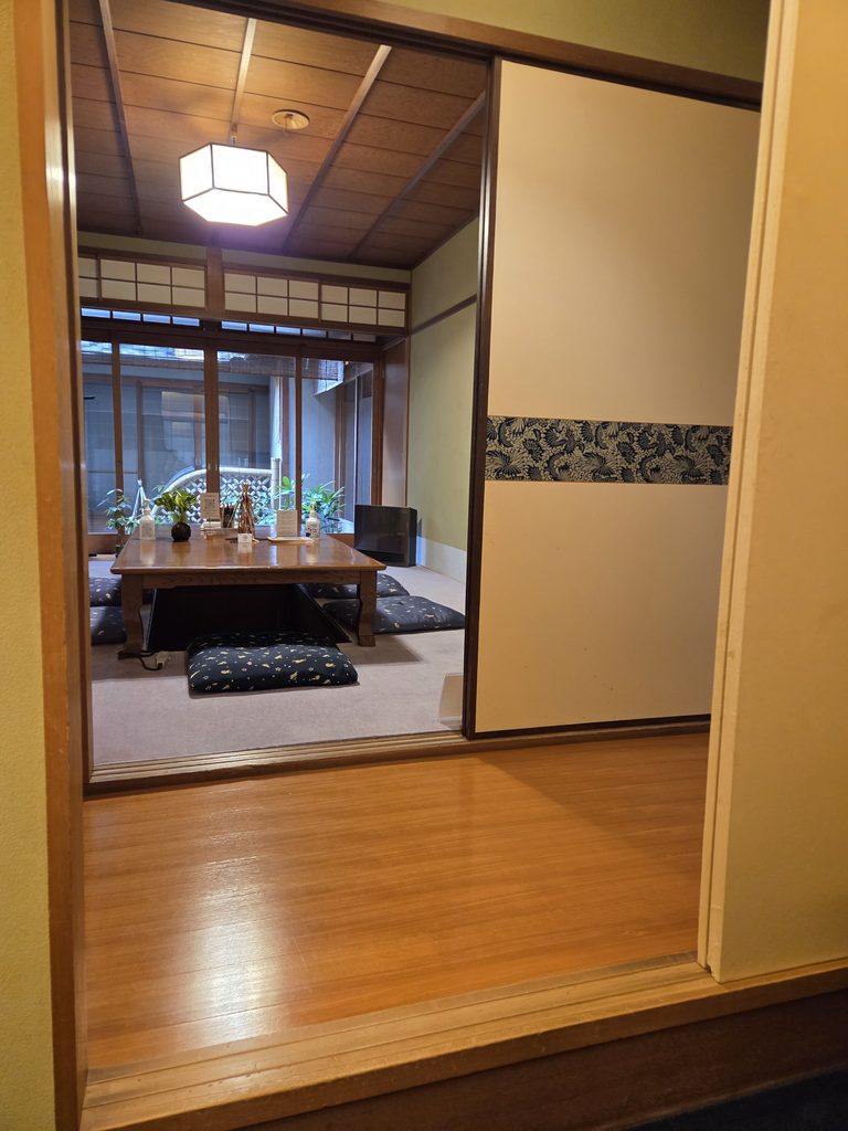 Traditional Japanese-style room with a low wooden table and floor cushions at Cafe Fugetsu in Gion